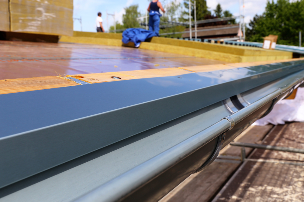 A metal drip edge on a gutter on a new tile roof.