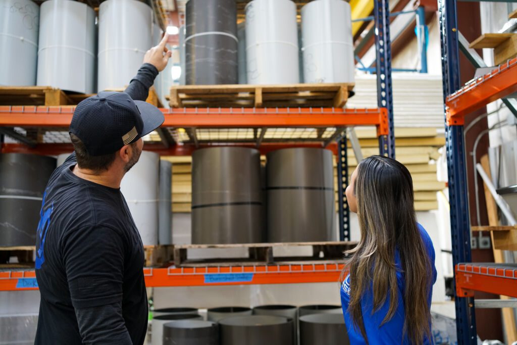 Two Metal Formers employees looking at roofing products