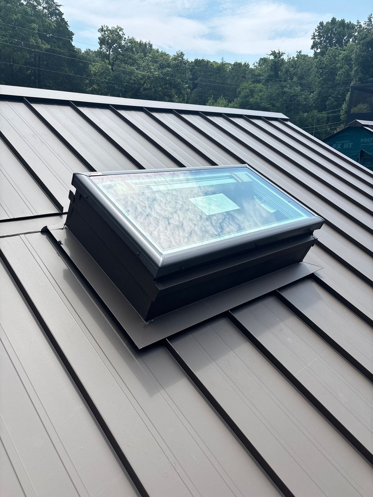 Skylight flashed into a Burnished Slate standing seam roof