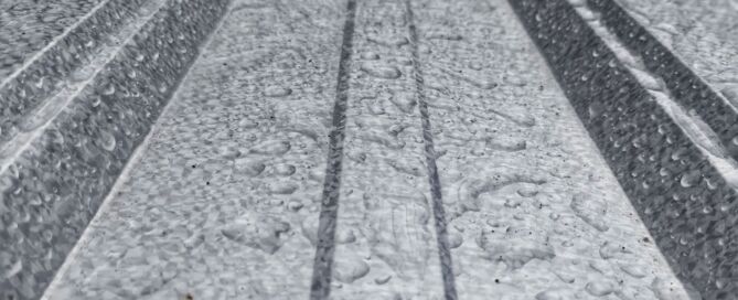 Close-up of condensation droplets beaded on ribbed metal roof panels